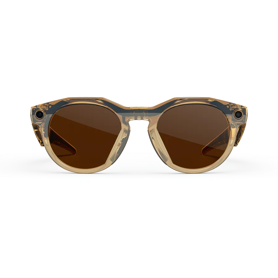 Front view of Oakley Meta HSTN glasses with a Light Curry frame and Clear to Brown Transitions lenses